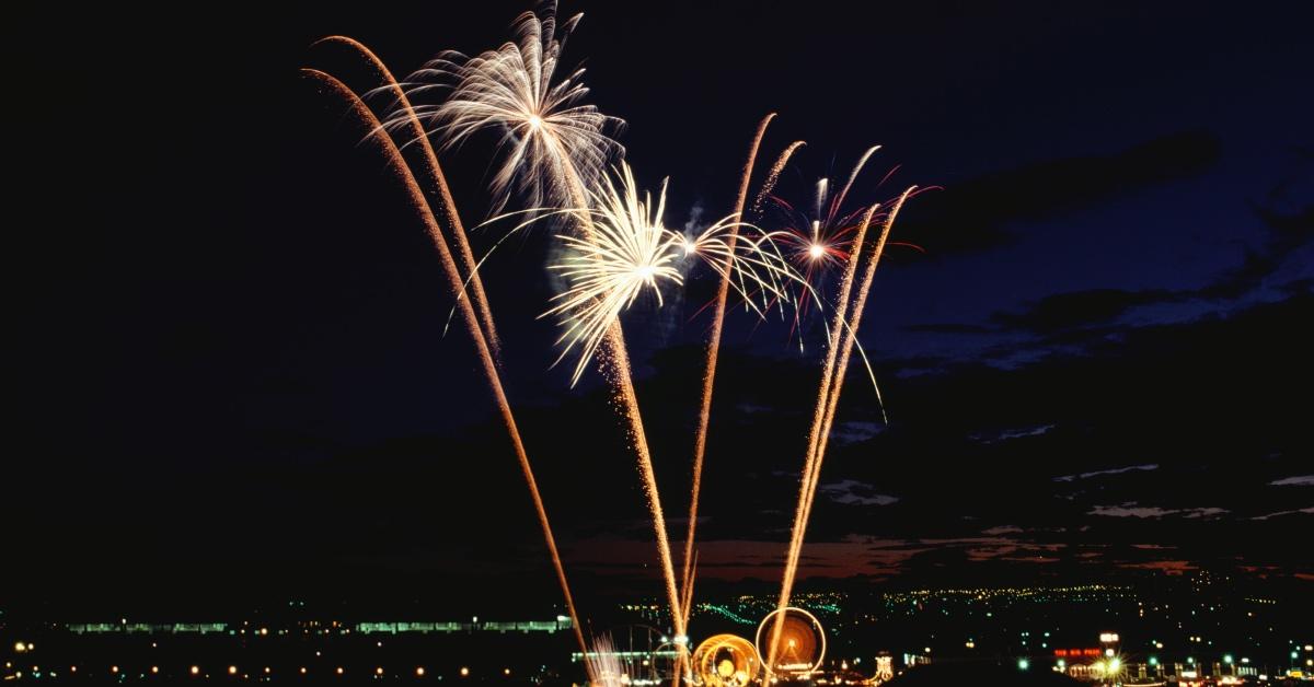 Fireworks in the sky above a darkened city. 