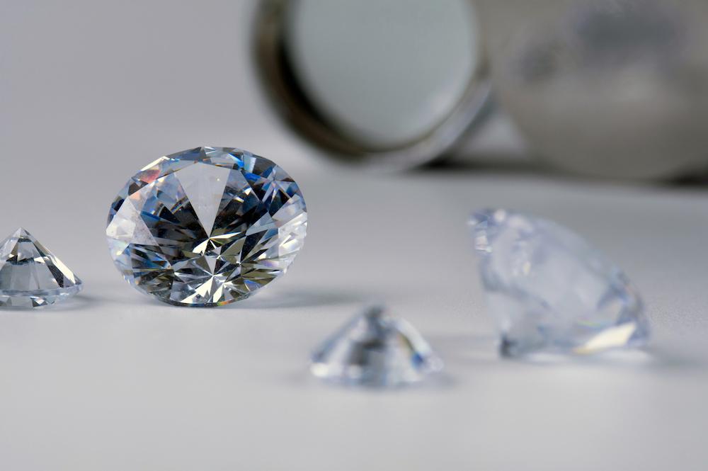 Close up diamonds on a white table.